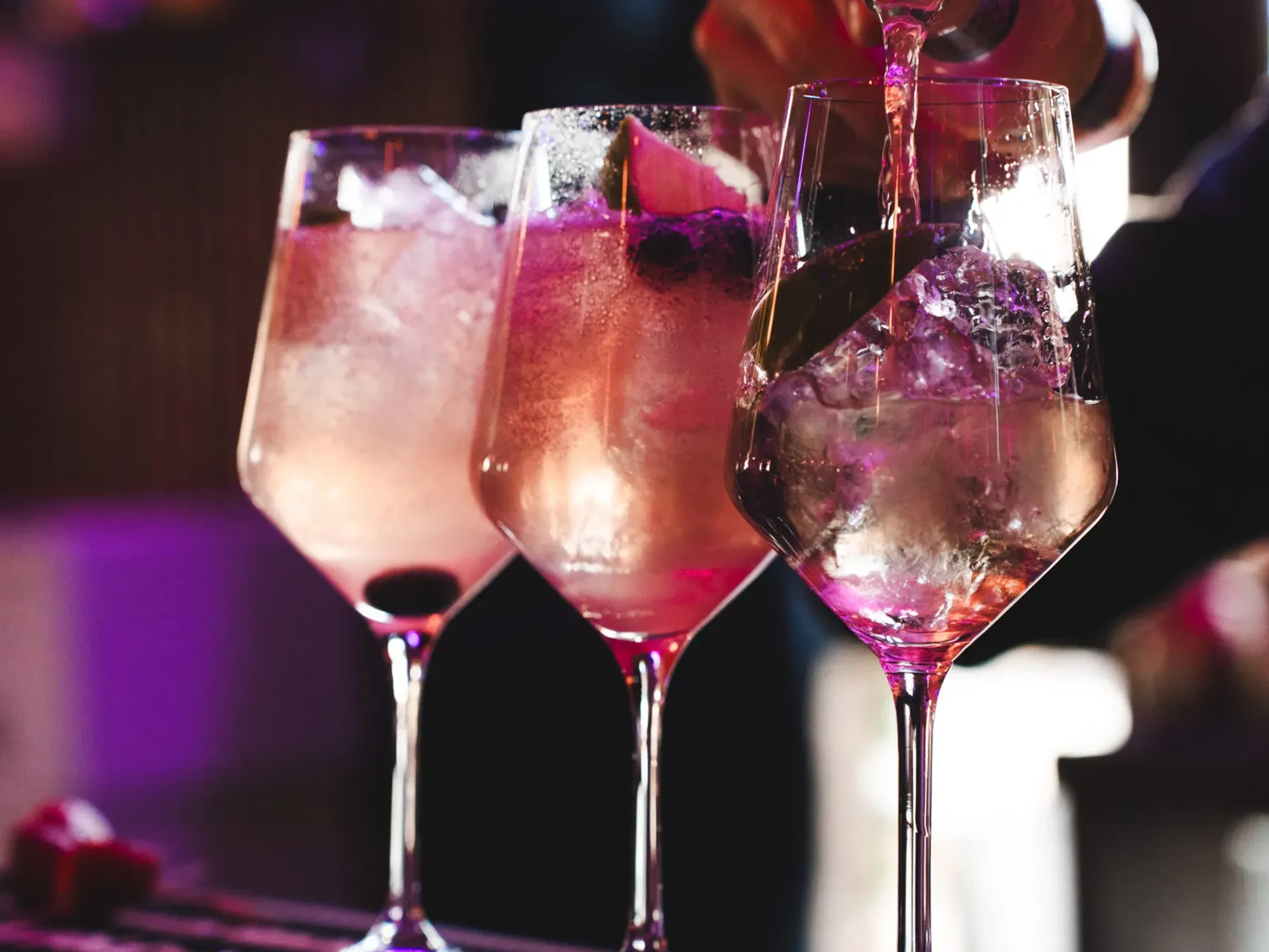 Signature cocktails lined up along the bar