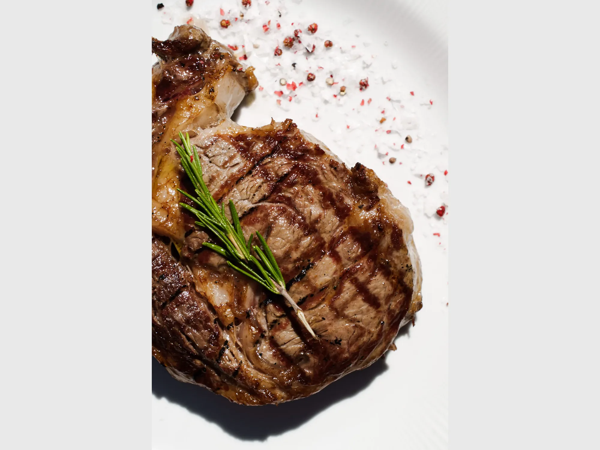 Grilled tomahawk steak served with rosemary